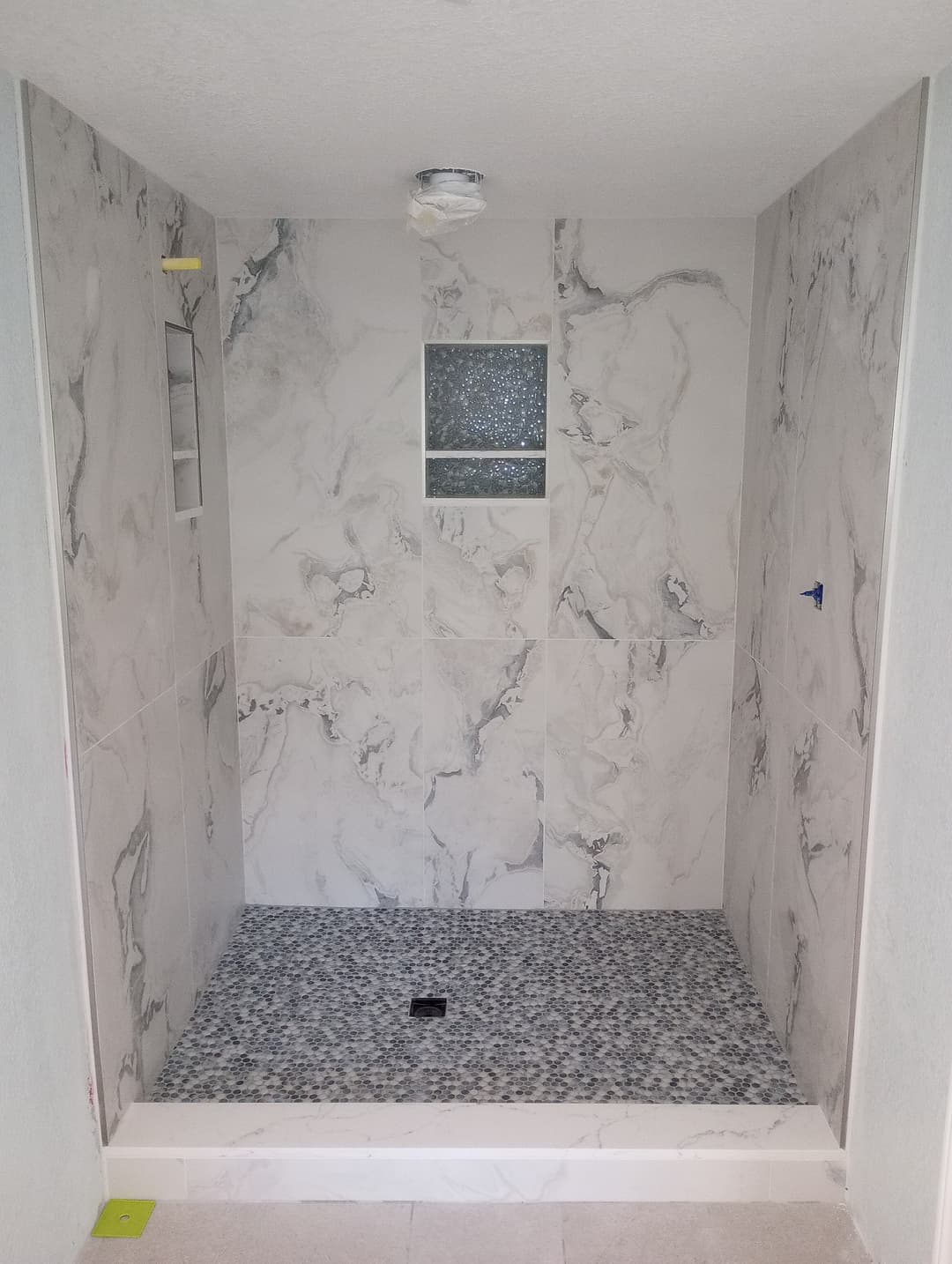 remodeled luxury bathroom with granbite tiles and custom luxury tile shower floor