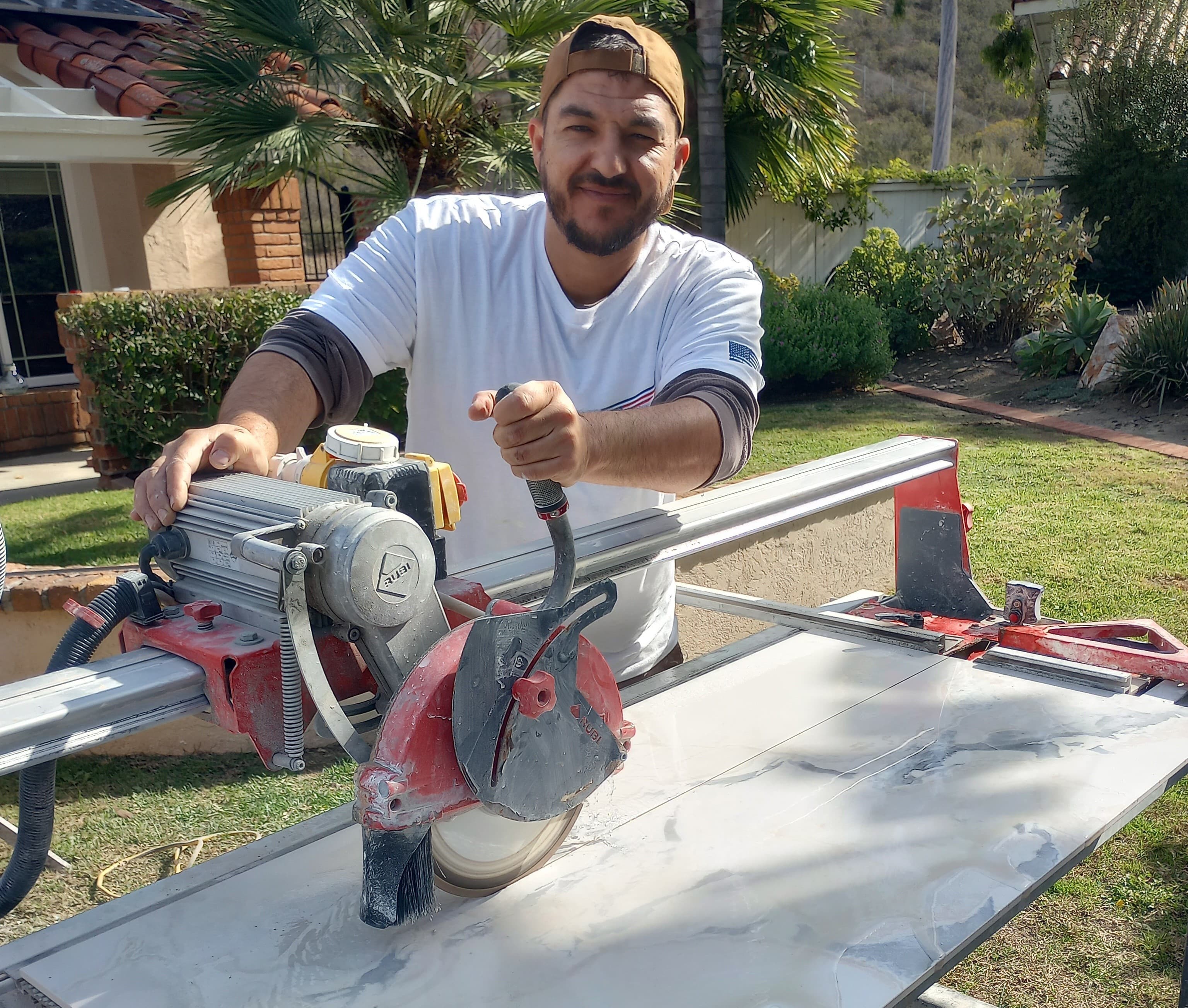 General contractor cutting a granite kitchen countertop with a saw blade