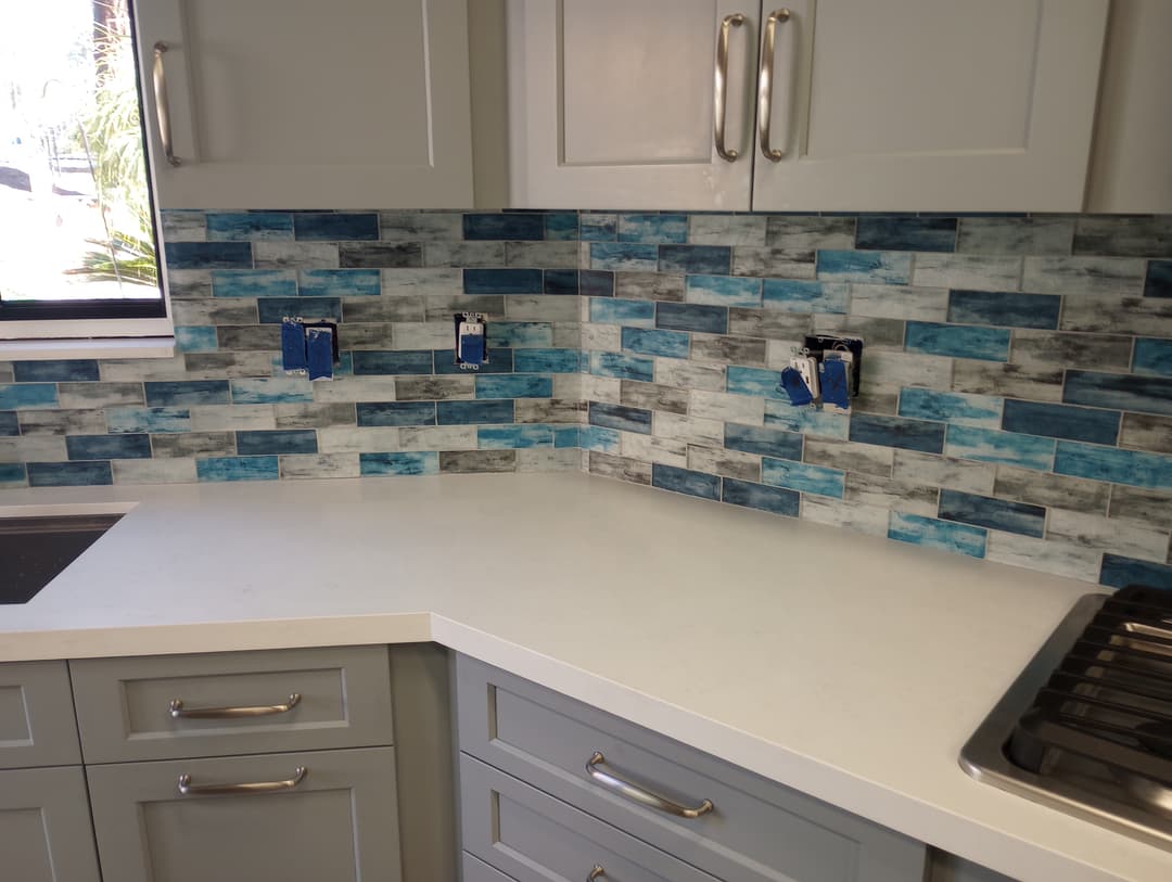 new remodeled kitchen countertop with granite blue tile backsplash